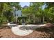 Charming coastal home surrounded by mature trees, showcasing a private driveway at 24 Beachwood West, Isle of Palms, SC 29451