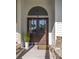 The house's double front doors are decorated with wreaths and a welcoming entry provides a seating area and potted plant at 24 Beachwood West, Isle of Palms, SC 29451