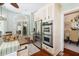 Kitchen features stainless steel appliances, built-in oven, and a kitchen island, adjoining the dining room at 24 Beachwood West, Isle of Palms, SC 29451