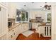 This functional kitchen design includes granite countertops, custom cabinets, stainless steel appliances, and hardwood floors at 24 Beachwood West, Isle of Palms, SC 29451