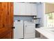 Functional laundry room with a washer, dryer, white cabinetry, and a window at 24 Beachwood West, Isle of Palms, SC 29451