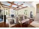 Bright living room with coffered ceilings, fireplace, hardwood floors, and ample natural light at 24 Beachwood West, Isle of Palms, SC 29451