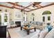 The spacious living room is highlighted by a fireplace, built-in shelving, hardwood floors, and large windows for natural light at 24 Beachwood West, Isle of Palms, SC 29451