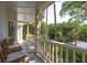 Charming porch with comfortable chairs surrounded by scenic nature views at 24 Beachwood West, Isle of Palms, SC 29451