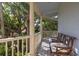 Inviting covered porch featuring comfortable chairs and lush greenery at 24 Beachwood West, Isle of Palms, SC 29451