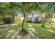 Lush backyard with a fire pit, trees, and plenty of room to relax at 2418 Castlereagh Rd, Charleston, SC 29414