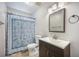 Cozy bathroom featuring a stylish vanity and mirror with a toilet and curtained shower at 2418 Castlereagh Rd, Charleston, SC 29414