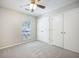 Comfortable bedroom featuring neutral decor, plush carpet, ample closet space, and a bright window at 2418 Castlereagh Rd, Charleston, SC 29414