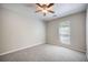 Bright bedroom with plush carpet and ceiling fan with a window for natural light at 2418 Castlereagh Rd, Charleston, SC 29414