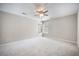 Spacious bedroom featuring plush carpeting, a ceiling fan, and natural light from two windows at 2418 Castlereagh Rd, Charleston, SC 29414