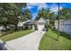 Well-maintained home with a one-car garage and a long driveway, surrounded by mature trees at 2418 Castlereagh Rd, Charleston, SC 29414