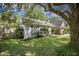 Charming home with beautiful landscaping, mature trees, and a well-maintained lawn at 2418 Castlereagh Rd, Charleston, SC 29414