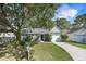 Charming single-story home featuring a well-manicured lawn and mature landscaping at 2418 Castlereagh Rd, Charleston, SC 29414