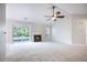 Bright living room with fireplace, ceiling fan, and sliding doors to the backyard deck at 2418 Castlereagh Rd, Charleston, SC 29414