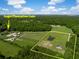 Aerial view of Angel Plantation estate featuring gated grounds, horse paddocks, and a private pond at 2470 Breakaway Trl, Johns Island, SC 29455