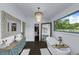 Bright bathroom with freestanding tub, vintage cabinet sink, large window, and decorative lighting at 2470 Breakaway Trl, Johns Island, SC 29455
