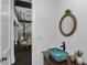 Unique rustic bathroom features a rope mirror and eye-catching sink and is open to the staircase at 2470 Breakaway Trl, Johns Island, SC 29455