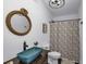 Stylish bathroom features a unique sink, rope mirror, and decorative shower curtain at 2470 Breakaway Trl, Johns Island, SC 29455