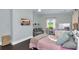 Charming bedroom with light walls, dark floors, styled decor, and natural light from the windows at 2470 Breakaway Trl, Johns Island, SC 29455