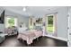 Bright bedroom featuring a large window, decor, and dark hardwood floors at 2470 Breakaway Trl, Johns Island, SC 29455