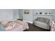 This inviting bedroom includes a sitting area, shelf decor, a TV, and plush bedding at 2470 Breakaway Trl, Johns Island, SC 29455