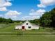Charming farmhouse-style home with fenced yard, play set, and picturesque landscaping at 2470 Breakaway Trl, Johns Island, SC 29455