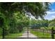 Angel Plantation gate with a scenic view down the tree-lined driveway at 2470 Breakaway Trl, Johns Island, SC 29455
