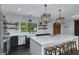 Modern kitchen featuring a large island with seating, stainless steel appliances, and stylish pendant lighting at 2470 Breakaway Trl, Johns Island, SC 29455