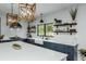 Modern kitchen with white countertops, dark cabinets, stainless steel appliances, and stylish pendant lighting at 2470 Breakaway Trl, Johns Island, SC 29455