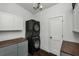Laundry room featuring stacked washer/dryer with dark cabinets and countertops at 2470 Breakaway Trl, Johns Island, SC 29455