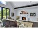 Comfortable living room featuring a fireplace and large windows offering backyard views at 2470 Breakaway Trl, Johns Island, SC 29455
