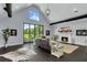 Living room boasts a fireplace, high ceilings and large windows with backyard views at 2470 Breakaway Trl, Johns Island, SC 29455