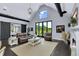 Bright living room featuring a fireplace and sliding barn doors leading into a bedroom at 2470 Breakaway Trl, Johns Island, SC 29455