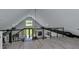 Open loft with stylish railings, natural light, and a view of the yard at 2470 Breakaway Trl, Johns Island, SC 29455
