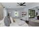 Spacious main bedroom featuring natural light, hardwood floors, ceiling fan, and tv at 2470 Breakaway Trl, Johns Island, SC 29455