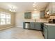 Well-lit kitchen featuring stainless steel appliances, white countertops, and painted blue cabinets at 258 Trickle Dr, Summerville, SC 29483