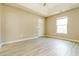 Spacious bedroom featuring tray ceiling, neutral walls, and light wood-look flooring at 258 Trickle Dr, Summerville, SC 29483