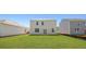 The home's backyard features well manicured grass and the home's exterior at 265 Wild Strawberry Ln, Moncks Corner, SC 29461
