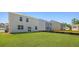 Wide shot of backyard with lush lawn and home with white siding at 265 Wild Strawberry Ln, Moncks Corner, SC 29461
