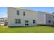 Wide shot of backyard featuring a lawn and the home's white siding at 265 Wild Strawberry Ln, Moncks Corner, SC 29461