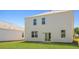 The home features a white exterior, sliding glass doors and a beautiful lawn at 265 Wild Strawberry Ln, Moncks Corner, SC 29461