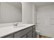 A well-lit bathroom featuring a vanity, a large mirror, and a bathtub with shower, providing a practical layout at 265 Wild Strawberry Ln, Moncks Corner, SC 29461
