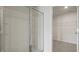 Modern bathroom showcasing a glass-enclosed shower with a glimpse into a walk-in closet with shelving at 265 Wild Strawberry Ln, Moncks Corner, SC 29461