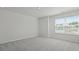 Bright bedroom with large window, neutral walls, and plush carpet, creating a welcoming and airy atmosphere at 265 Wild Strawberry Ln, Moncks Corner, SC 29461