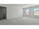 A bright bedroom featuring windows, neutral walls, and plush carpeting, offering a serene and light-filled space at 265 Wild Strawberry Ln, Moncks Corner, SC 29461