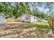 Spacious backyard featuring a fenced in yard with large trees offering plenty of shade on a sunny day at 2678 Ranger Dr, North Charleston, SC 29405
