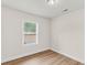 Bright bedroom featuring a window with blinds, wood floors, and neutral color palette at 2678 Ranger Dr, North Charleston, SC 29405