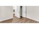 Cozy bedroom featuring wood floors, closet with doors, and views to the kitchen at 2678 Ranger Dr, North Charleston, SC 29405
