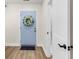 Charming entryway featuring a light blue front door adorned with a floral wreath and wood-look flooring at 2678 Ranger Dr, North Charleston, SC 29405
