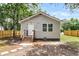 Charming home featuring gray siding, a quaint front porch with a wooden staircase, and a privacy fence at 2678 Ranger Dr, North Charleston, SC 29405